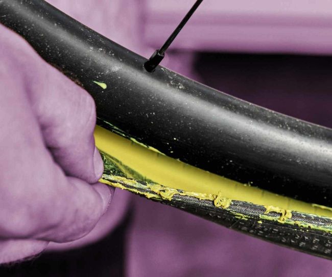 Close-up of tubeless tyre bead with yellow sealant residue visible