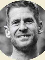 Smiling man outdoors, black and white portrait