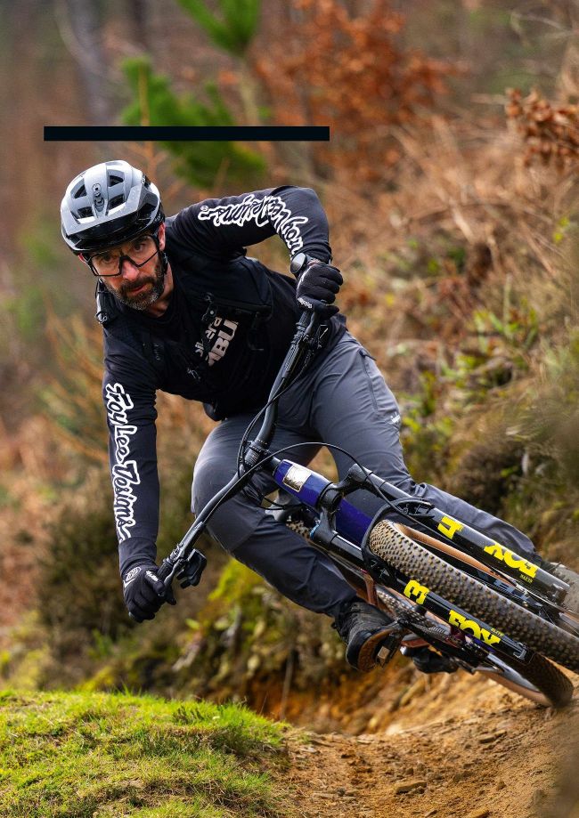 Rider aggressively cornering on Marin Tam XR mountain bike on trail