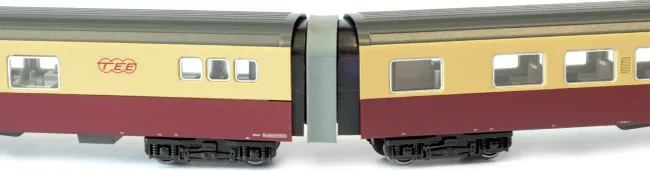 Two views of the Kato SBB RAe II TEE intermediate cars showing side detail and bogie arrangement in red and cream livery.