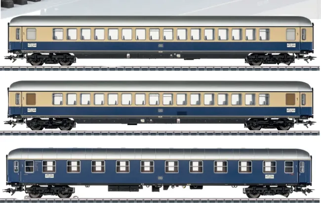 Three Märklin/Trix HO scale DB passenger coaches in blue and cream TEE livery variants shown individually on track.